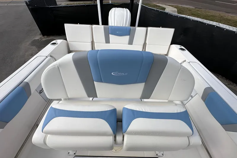Slide: The Image of 2024 Robalo R232 Explorer boat interior with blue and white seating. - 44