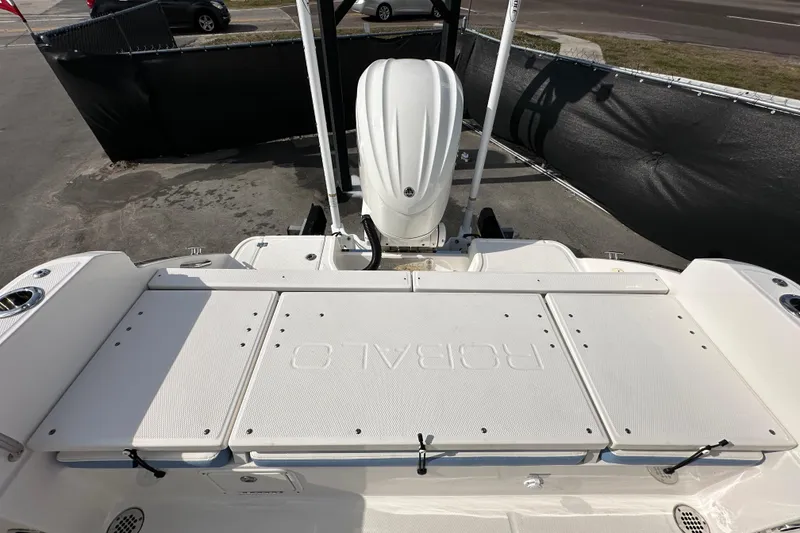 Slide: The Image of 2024 Robalo R232 Explorer boat deck with engine, showcasing sleek design and functionality. - 46