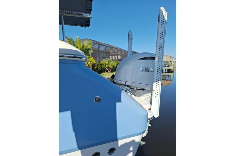 Slide: The Image of 2024 Robalo R232 Explorer boat with Yamaha engine, parked under a cloudy sky. - 5