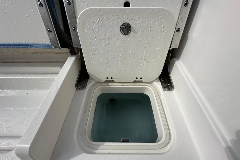 Slide: The Image of 2024 Robalo R232 Explorer livewell with water droplets on lid. - 50