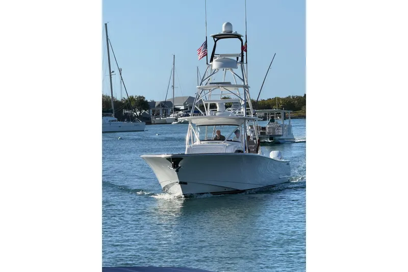 Slide: The Image of 2021 Valhalla Boatworks V-46 with multiple outboard engines docked by waterfront homes. - 14