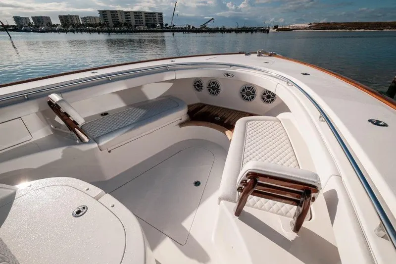 Slide: The Image of 2021 Valhalla Boatworks V-46 with luxurious seating, docked near waterfront homes. - 19
