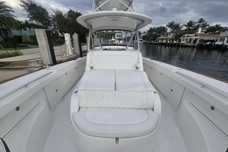 Slide: The Image of 2021 Valhalla Boatworks V-46 docked under cloudy sky, showcasing sleek design. - 24