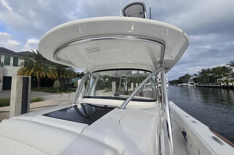 Slide: The Image of 2021 Valhalla Boatworks V-46, open cabin entrance, docked near another vessel. - 26