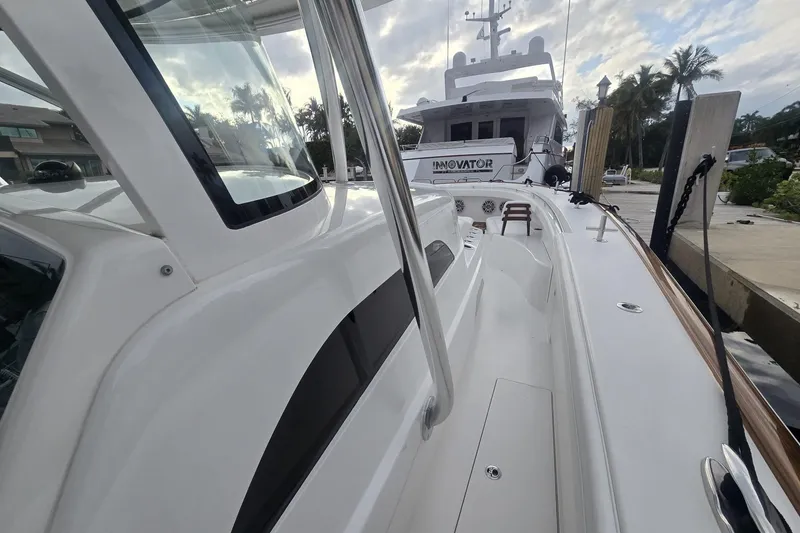 Slide: The Image of 2021 Valhalla Boatworks V-46 interior with cushioned seating and rod holders. - 28