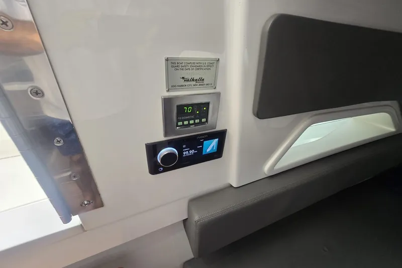 Slide: The Image of Electrical control panel on 2021 Valhalla Boatworks V-46, featuring switches and circuit breakers. - 49