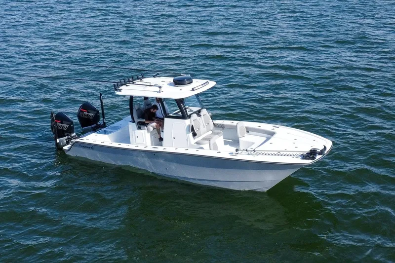 Slide: The Image of 2024 Freeman 28 boat on open water, featuring dual engines and sleek design. - 0