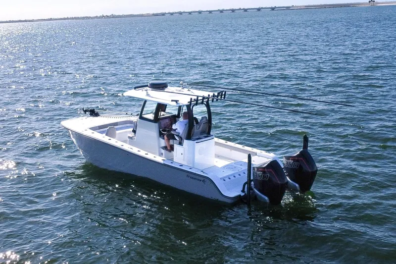 Slide: The Image of 2024 Freeman 28 boat on open water, featuring dual outboard motors. - 1