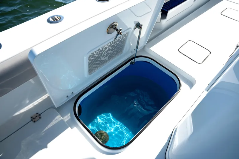 Slide: The Image of Freeman 28 boat livewell, 2024 model, open hatch with water inside, sleek design. - 10