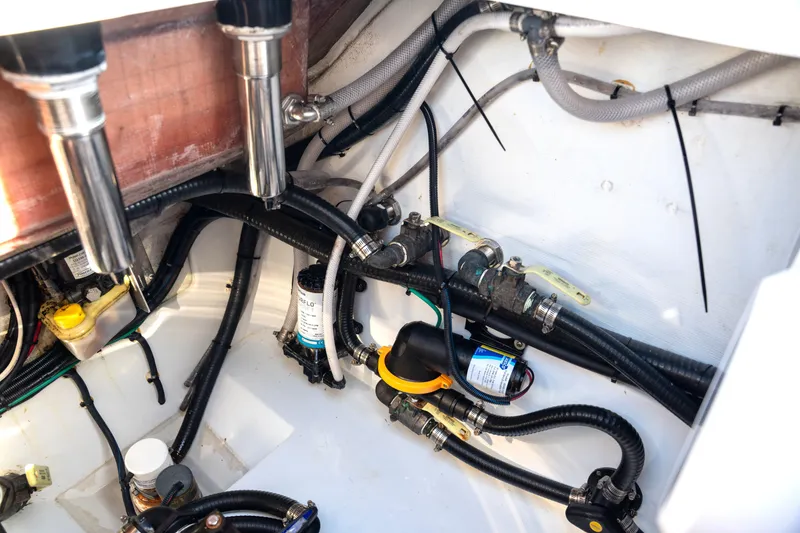 Slide: The Image of Engine compartment of a 2024 Freeman 28 boat, showcasing wiring and plumbing details. - 12