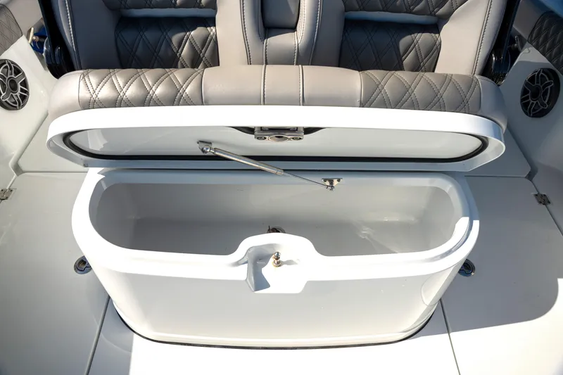 Slide: The Image of Open storage compartment on a 2024 Freeman 28 boat with quilted seating. - 15