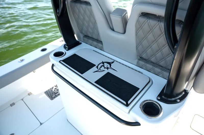 Slide: The Image of 2024 Freeman 28 boat interior with cushioned seating and cup holders on deck. - 18