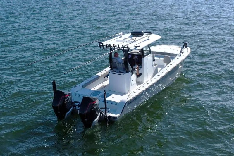 Slide: The Image of 2024 Freeman 28 boat with dual engines on open water. - 2