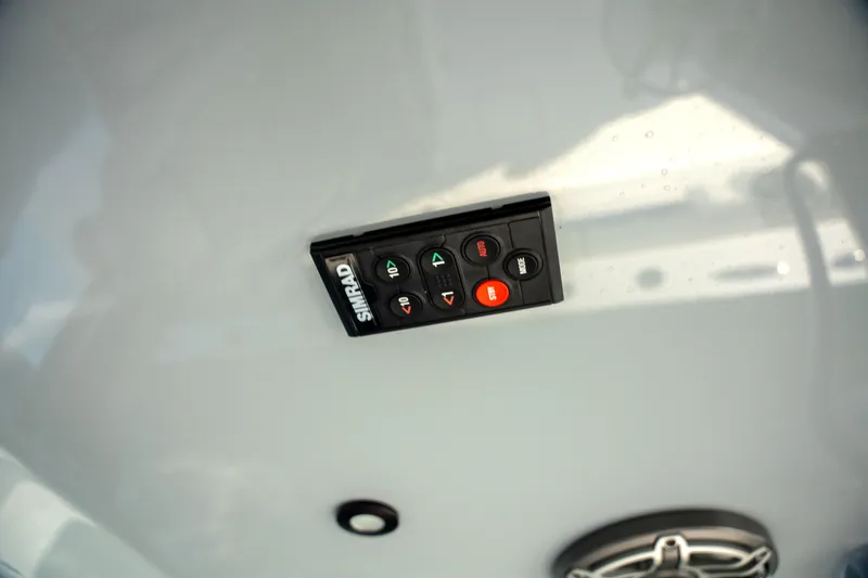 Slide: The Image of Simrad control panel on Freeman 28 boat, 2024 model, featuring navigation buttons. - 28