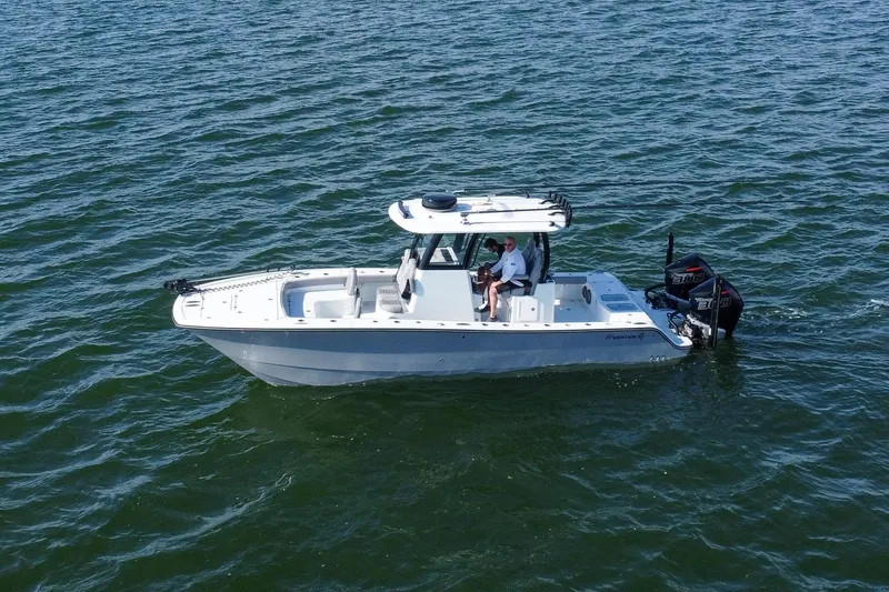 Slide: The Image of 2024 Freeman 28 boat on open water, featuring dual engines and sleek design. - 3