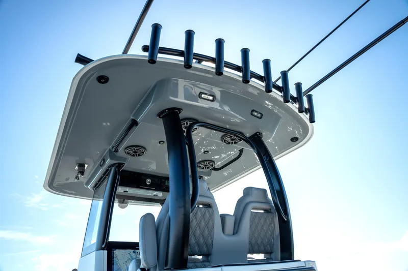 Slide: The Image of 2024 Freeman 28 boat with sleek design and modern seating under a clear blue sky. - 33