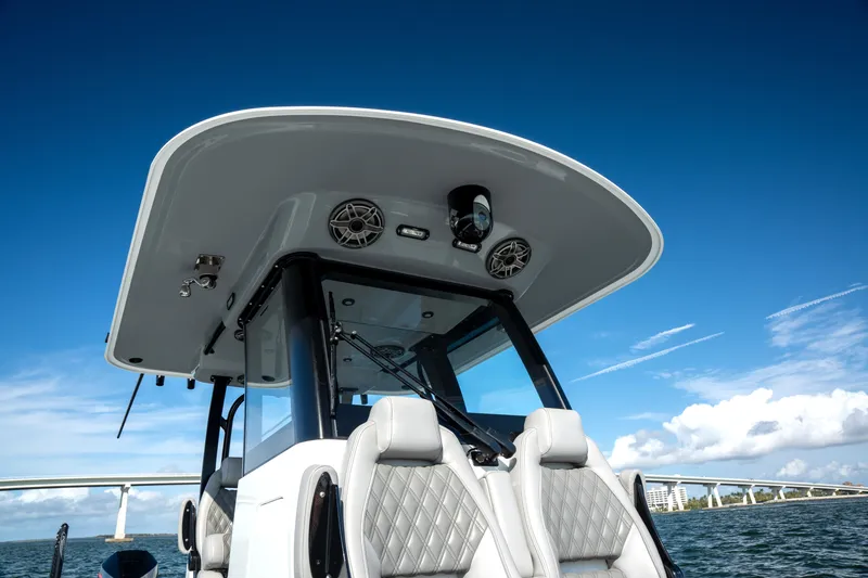 Slide: The Image of 2024 Freeman 28 boat with sleek design, modern seating, and clear blue sky backdrop. - 34