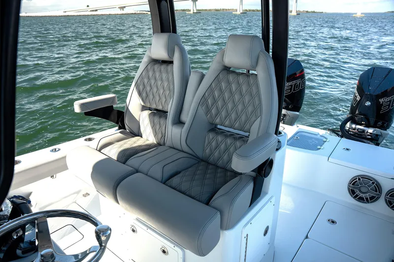 Slide: The Image of 2024 Freeman 28 boat interior with luxurious seating and dual engines on the water. - 35