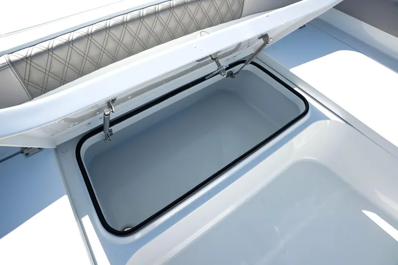 Slide: The Image of Open storage compartment on 2024 Freeman 28 boat with cushioned seating. - 38