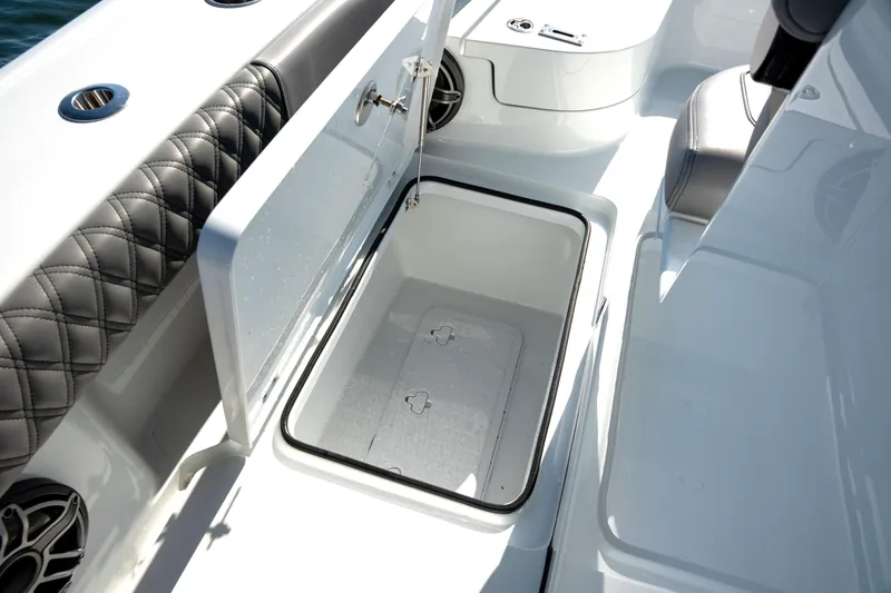 Slide: The Image of Open storage compartment on 2024 Freeman 28 boat with quilted seating. - 5