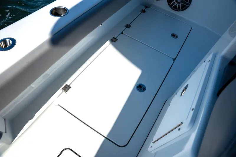 Slide: The Image of 2024 Freeman 28 boat deck with storage compartments and cup holders. - 6