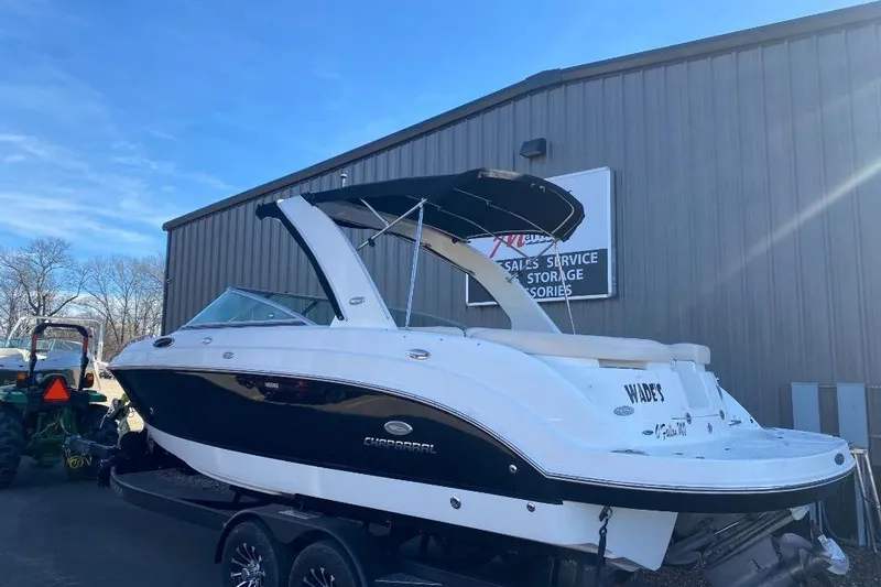 Slide: The Image of 2006 Chaparral 256 SSi boat parked in front of a building. - 0