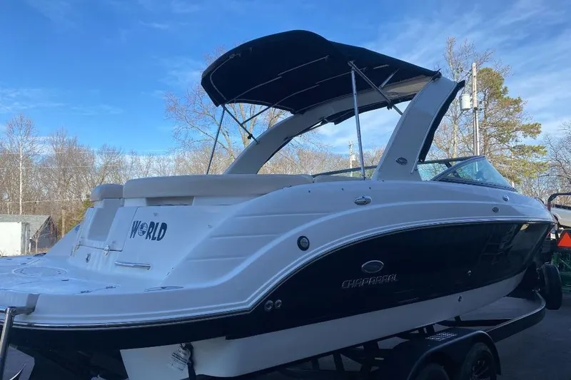 Slide: The Image of 2006 Chaparral 256 SSi boat with canopy, parked outdoors on a trailer. - 3