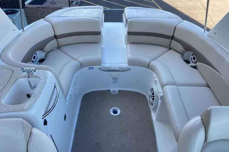 Slide: The Image of 2006 Chaparral 256 SSi boat interior with beige seating and built-in speakers. - 5