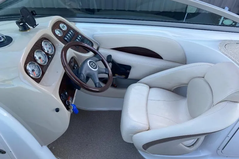 Slide: The Image of 2006 Chaparral 256 SSi boat cockpit with steering wheel and gauges. - 6