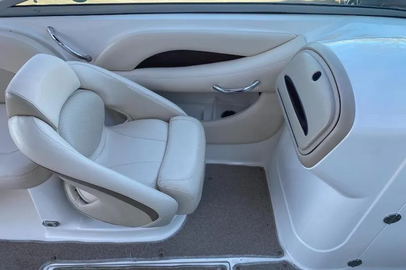 Slide: The Image of 2006 Chaparral 256 SSi boat interior with beige seating and sleek design. - 7