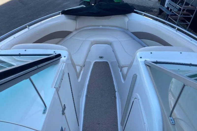 Slide: The Image of 2006 Chaparral 256 SSi boat interior with white seating and open deck layout. - 9