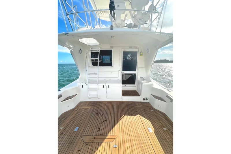 Slide: The Image of 1999 Wellcraft 400 Coastal boat deck with wooden flooring and ocean view. - 15
