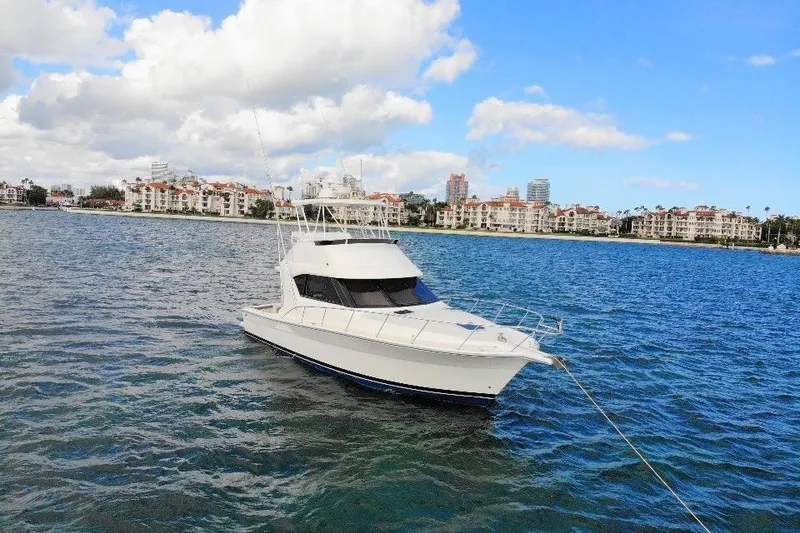 Slide: The Image of 1999 Wellcraft 400 Coastal yacht anchored in scenic coastal waters. - 18