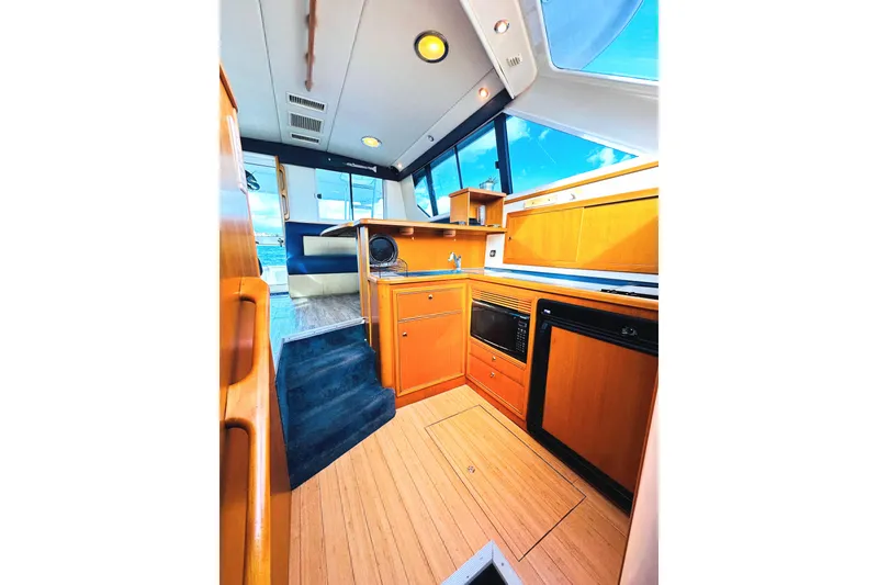 Slide: The Image of Interior of 1999 Wellcraft 400 Coastal yacht with modern kitchen and seating area. - 26
