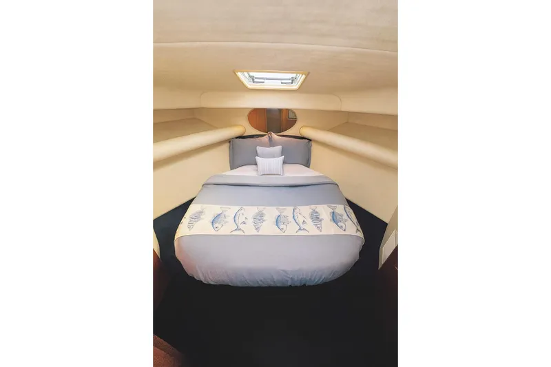 Slide: The Image of Cozy cabin interior of 1999 Wellcraft 400 Coastal boat with nautical-themed bedding. - 3