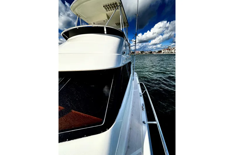 Slide: The Image of 1999 Wellcraft 400 Coastal yacht on water under cloudy sky. - 32