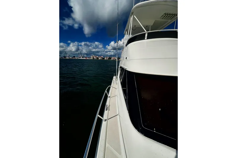 Slide: The Image of 1999 Wellcraft 400 Coastal yacht on open water under a partly cloudy sky. - 33