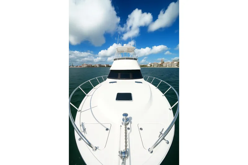 Slide: The Image of 1999 Wellcraft 400 Coastal yacht on water under blue sky and clouds. - 35