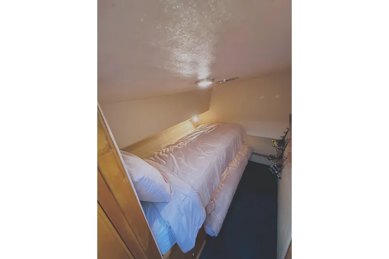 Slide: The Image of Cozy cabin interior of 1999 Wellcraft 400 Coastal boat with single bed and soft lighting. - 6