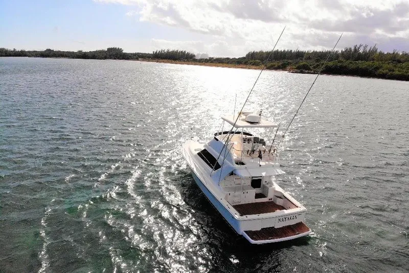 Slide: The Image of 1999 Wellcraft 400 Coastal yacht on shimmering water under a bright sky. - 9
