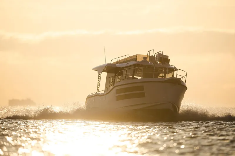 Slide: The Image of Northman 1050 boat cruising at sunset, 2025 model, on shimmering water. - 11