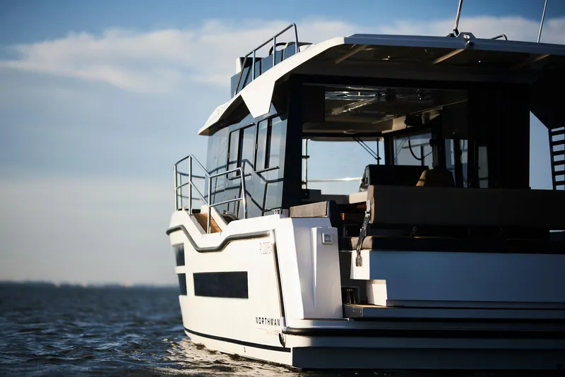 Slide: The Image of Modern Northman 1050 yacht on open water, 2025 model, sleek design, sunny day. - 14
