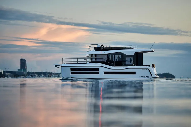 Slide: The Image of Modern Northman 1050 yacht on calm water at sunset, 2025 model. - 2