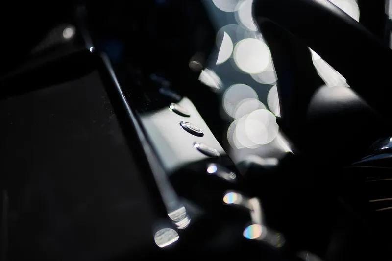 Slide: The Image of Close-up of Northman 1050 dashboard buttons, 2025 model, with blurred background lights. - 21
