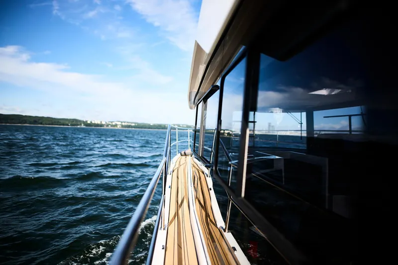 Slide: The Image of 2025 Northman 1050 yacht cruising on open water under a clear blue sky. - 35