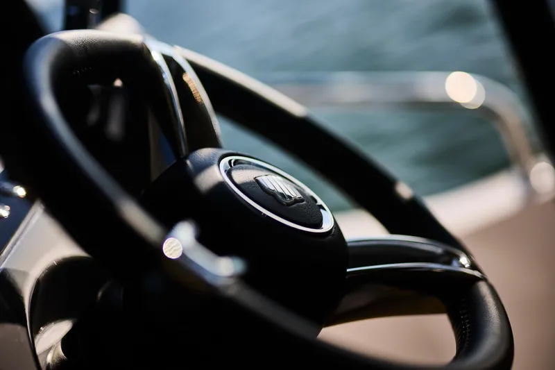 Slide: The Image of Steering wheel of 2025 Northman 1050 boat, close-up view with blurred background. - 22