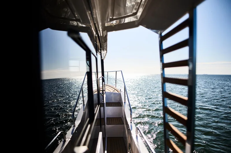 Slide: The Image of View from Northman 1050 boat, 2025 model, overlooking sparkling ocean waters. - 23