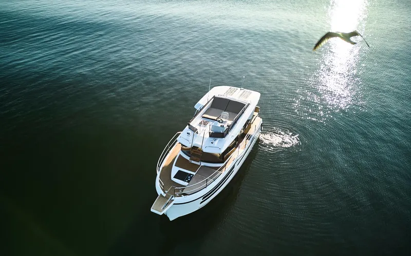 Slide: The Image of Aerial view of 2025 Northman 1050 yacht on calm water with a bird flying nearby. - 31