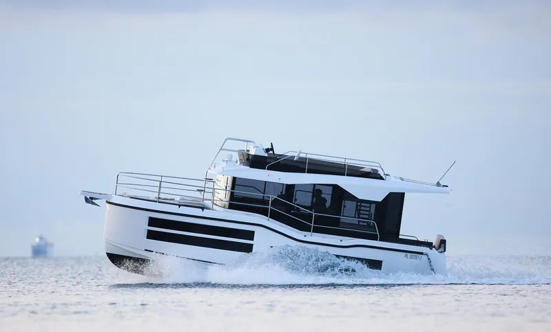 Slide: The Image of 2025 Northman 1050 boat cruising on open water, showcasing sleek design and modern features. - 5