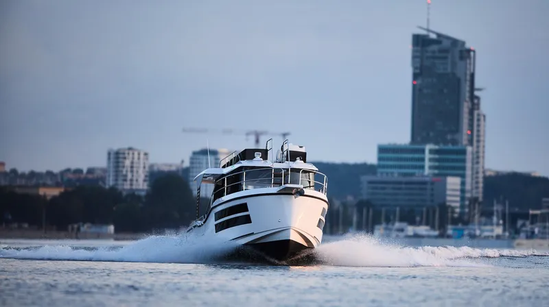 Slide: The Image of Modern Northman 1050 boat cruising near city skyline, 2025 model. - 7